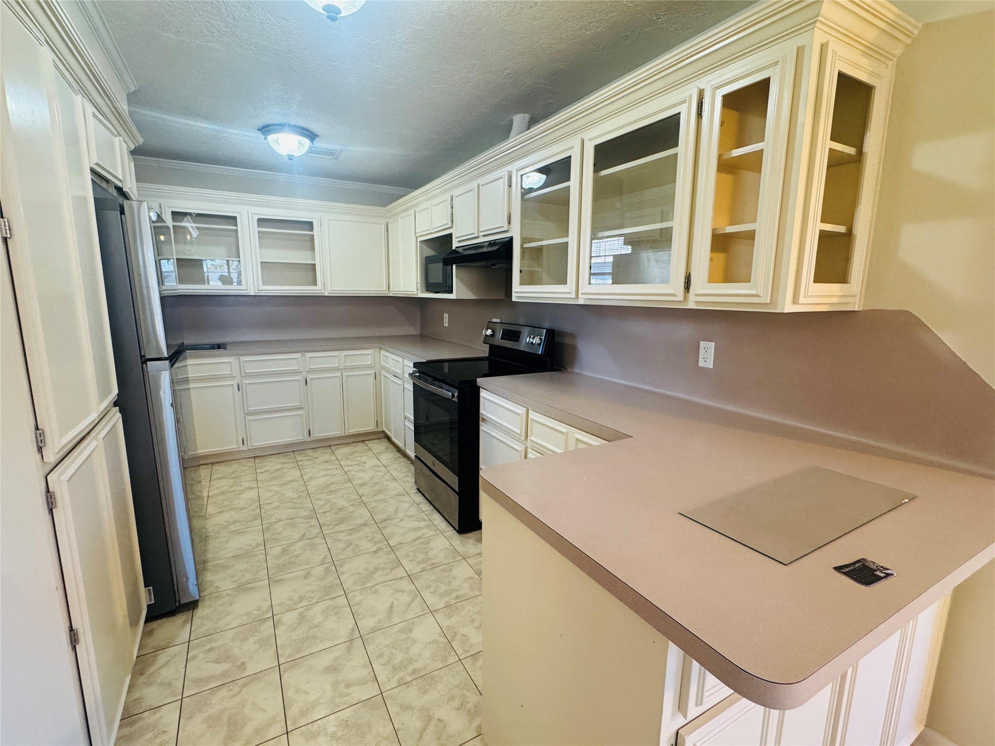 605 Tovrea Road Alvin, TX 77511 - Photo 13 of 18 a kitchen with a sink a stove and a refrigerator