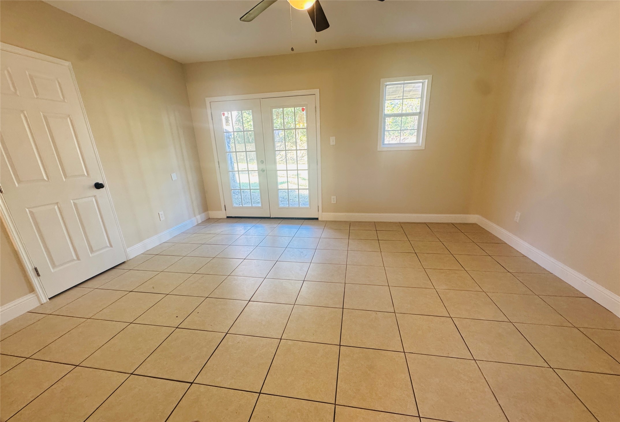 605 Tovrea Road Alvin, TX 77511 - Photo 18 of 18 a view of an empty room and window and chandelier fan