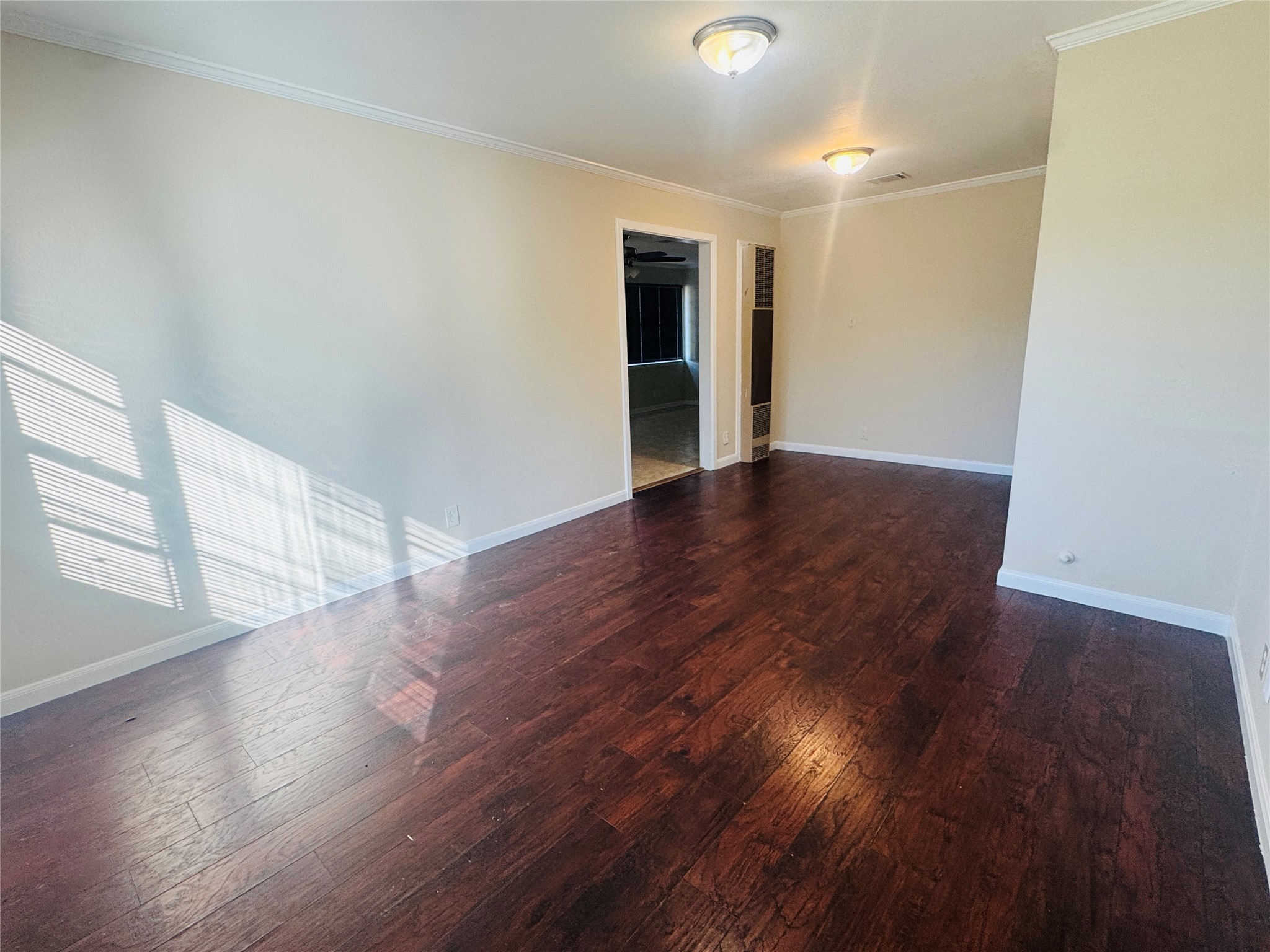 605 Tovrea Road Alvin, TX 77511 - Photo 2 of 18 a view of an empty room with wooden floor and a window