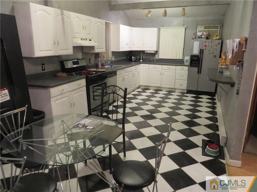 88 Princeton Road Old Bridge, NJ 08859 - Photo 2 of 10 a kitchen with a sink a stove and a refrigerator
