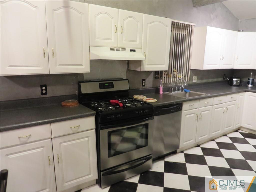 88 Princeton Road Old Bridge, NJ 08859 - Photo 3 of 10 a kitchen with a sink stove and cabinets
