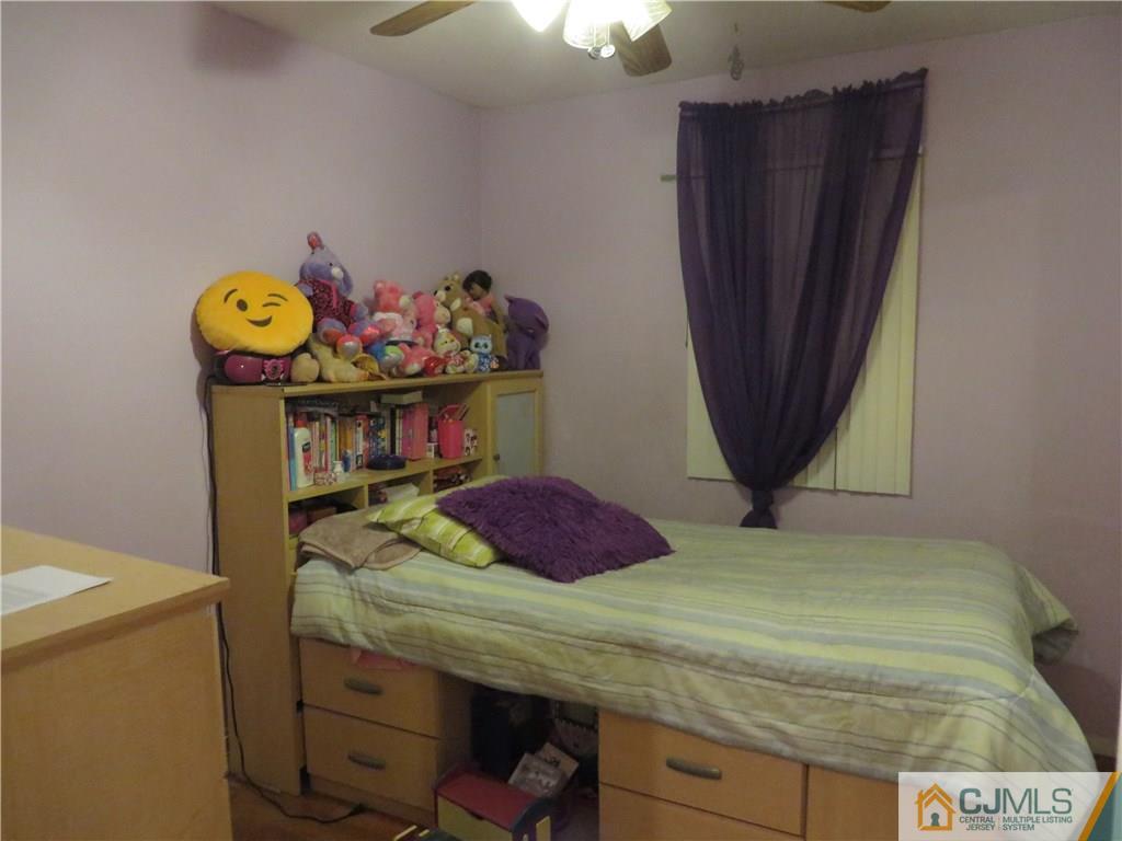 88 Princeton Road Old Bridge, NJ 08859 - Photo 6 of 10 a bedroom with a bed and a table