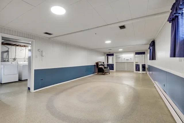 a view of a livingroom with kitchen and furniture