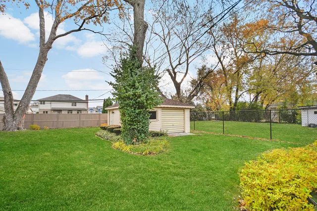 a view of backyard of house with large trees