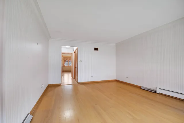 a view of a room with wooden floor and white walls
