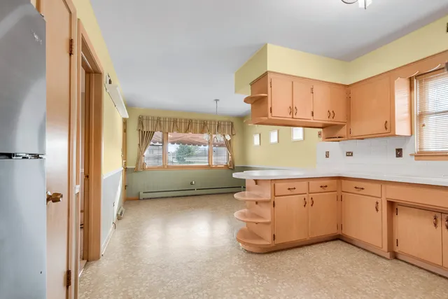 a kitchen with cabinets a sink and appliances