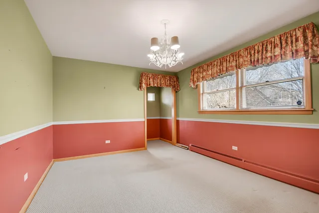 a view of room with window and chandelier
