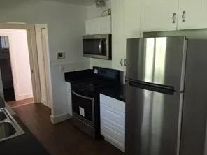 a kitchen with a refrigerator and a sink
