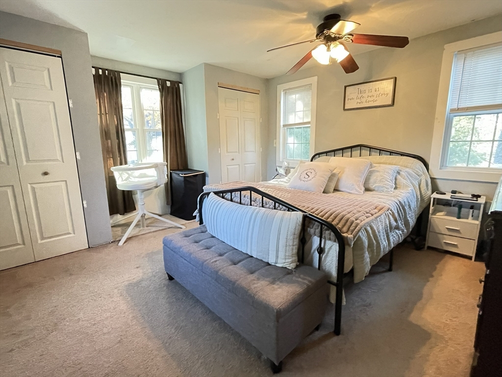 9 Watt Road Worcester, MA 01606 - Photo 19 of 36 a spacious bedroom with a bed couch and a window