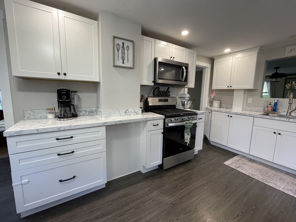 9 Watt Road Worcester, MA 01606 - Photo 8 of 36 a kitchen with white cabinets stainless steel appliances and sink