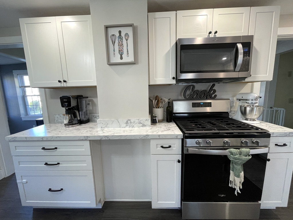 9 Watt Road Worcester, MA 01606 - Photo 9 of 36 a kitchen with stainless steel appliances a stove a microwave and cabinets
