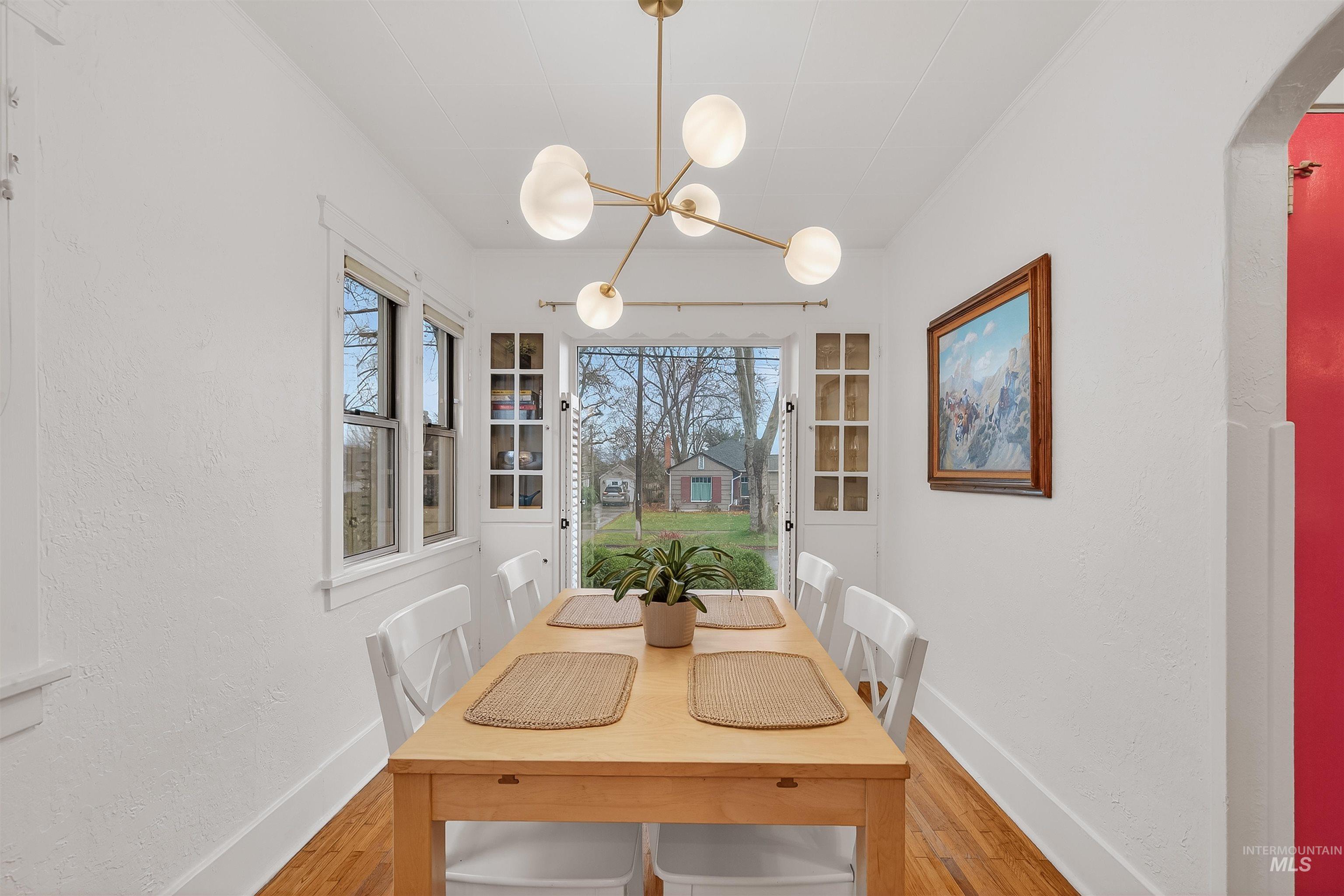 1209 3rd Street Lewiston, ID 83501 - Photo 17 of 49 Dining space featuring light wood-style floors, arched walkways, and a textured wall