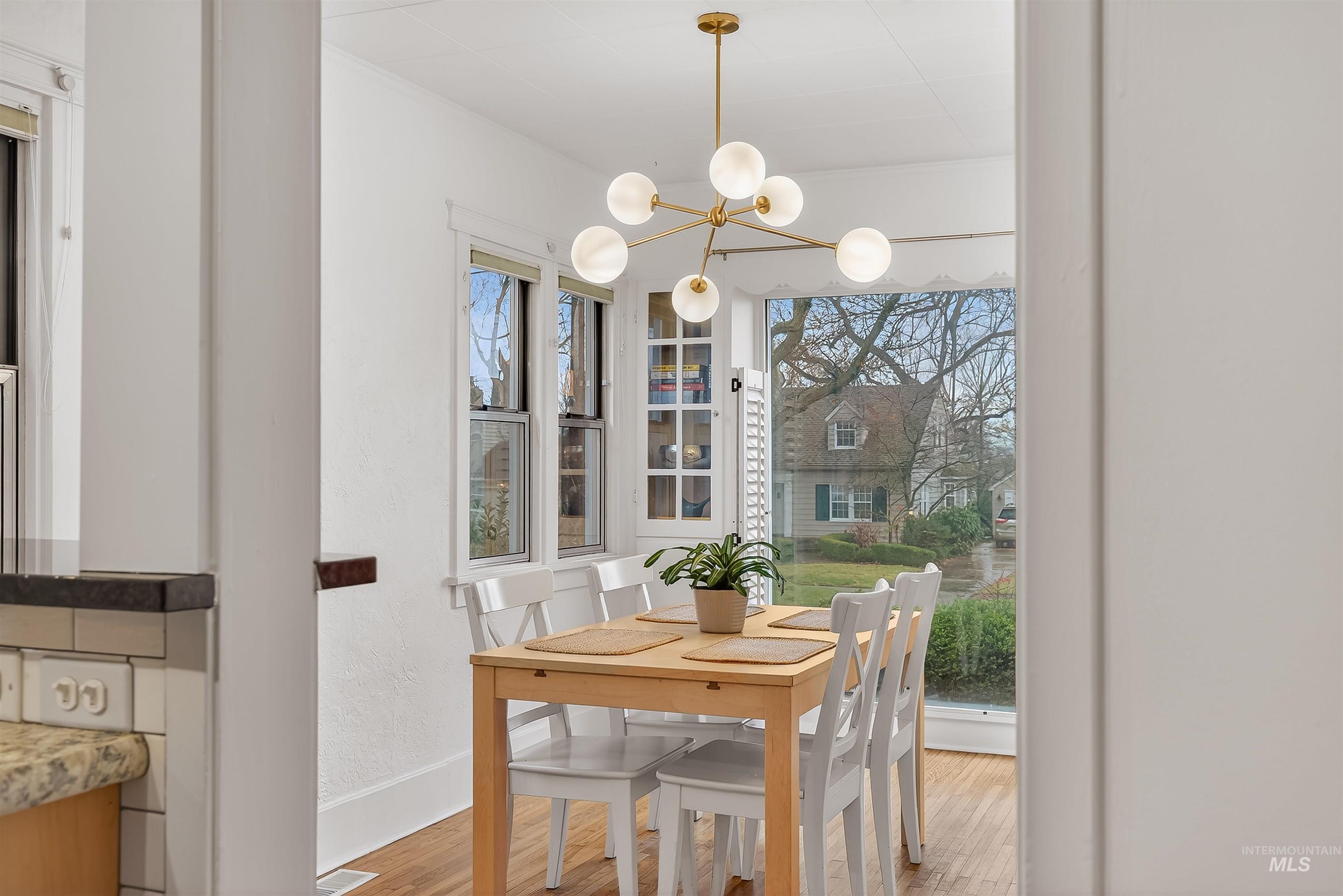 1209 3rd Street Lewiston, ID 83501 - Photo 28 of 49 Dining space with wood finished floors, a chandelier, and a textured wall