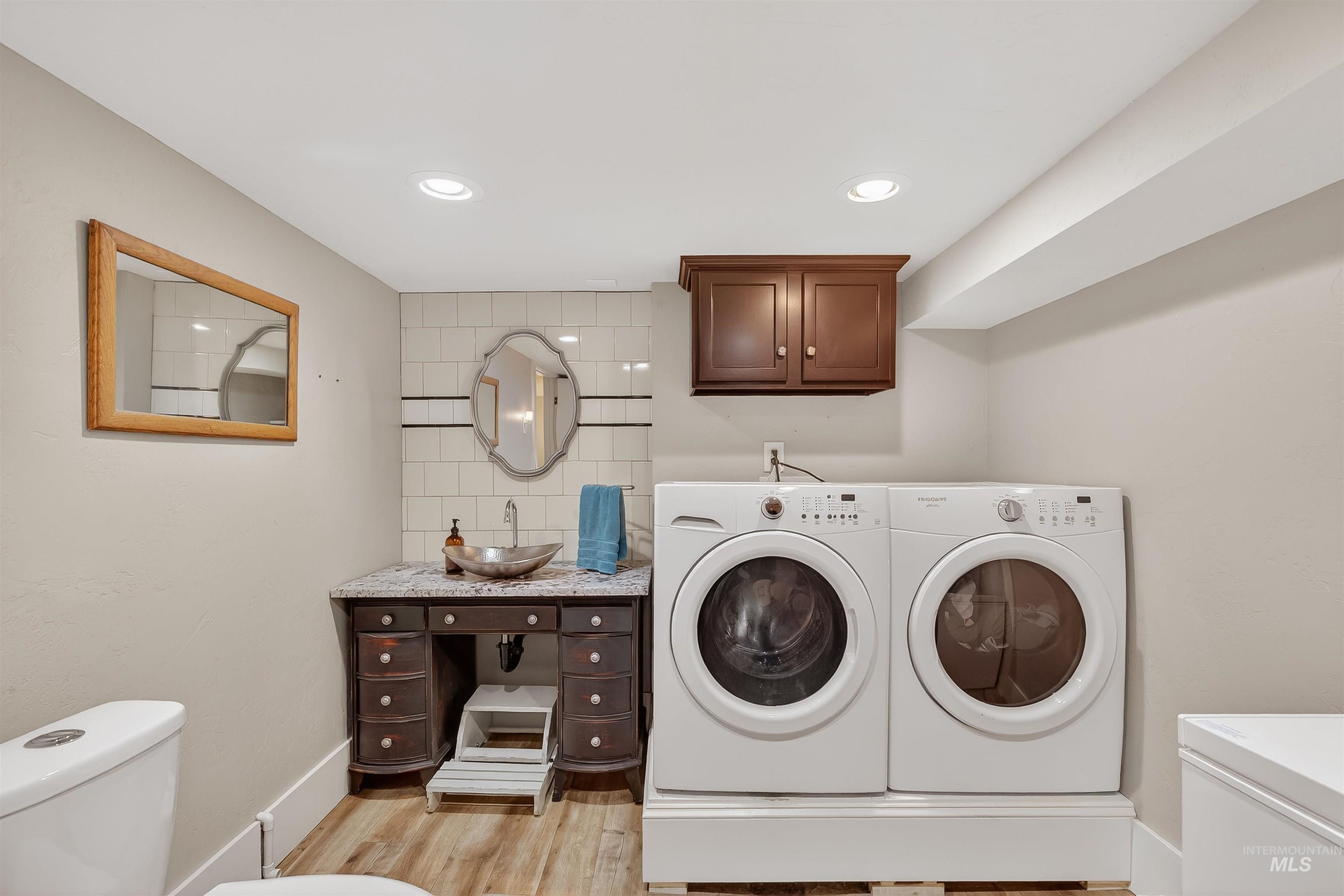 1209 3rd Street Lewiston, ID 83501 - Photo 31 of 49 Laundry area featuring light wood finished floors, recessed lighting, and washing machine and clothes dryer