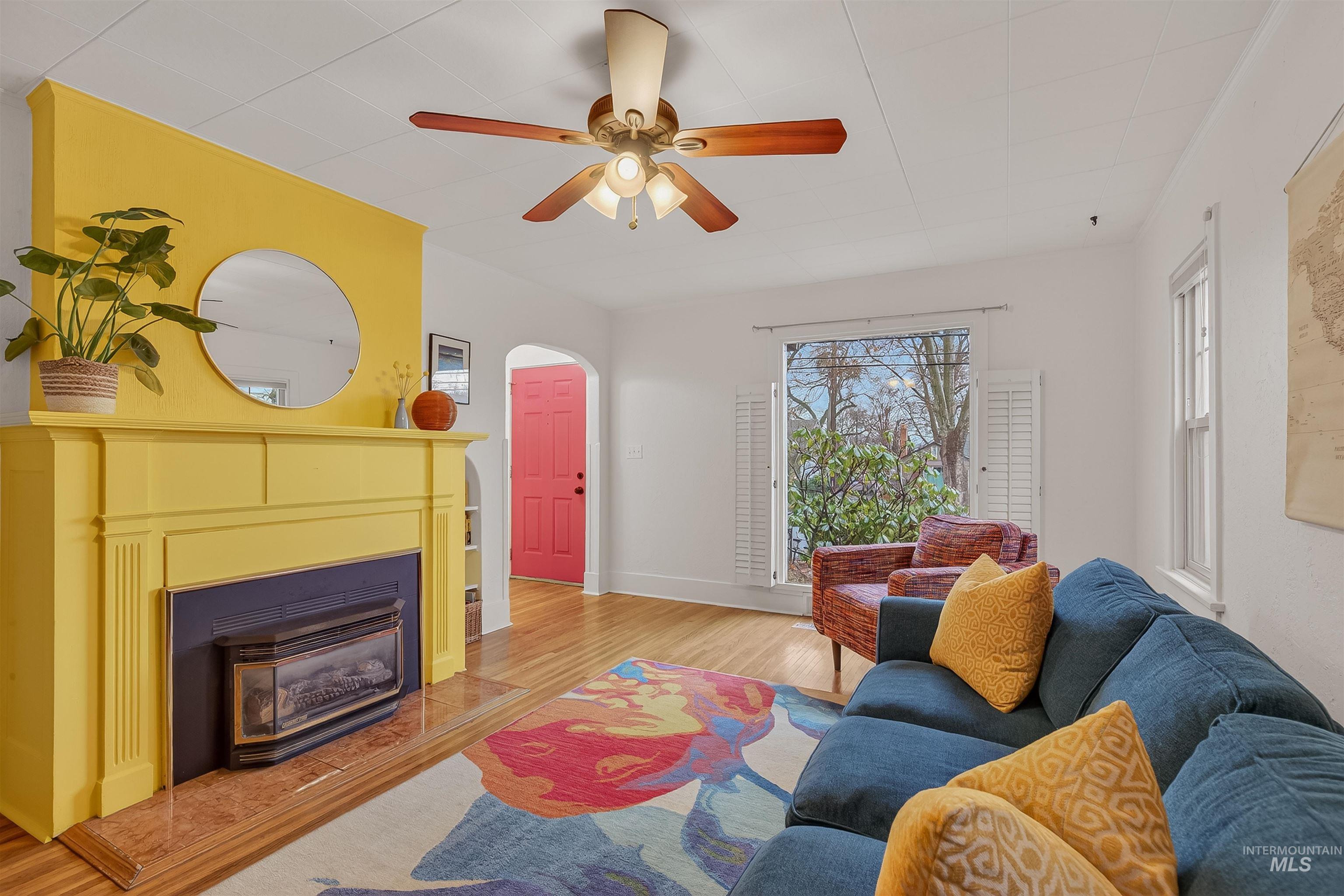 1209 3rd Street Lewiston, ID 83501 - Photo 5 of 49 Living room with light wood-style floors, ceiling fan, arched walkways, and a glass covered fireplace