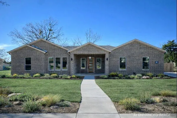 a front view of house with yard and green space