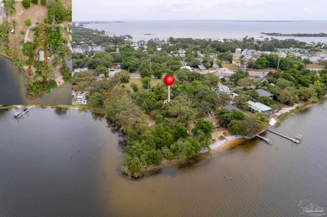 an aerial view of residential house with outdoor space and trees all around