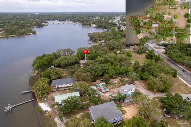 an aerial view of house with yard and lake view