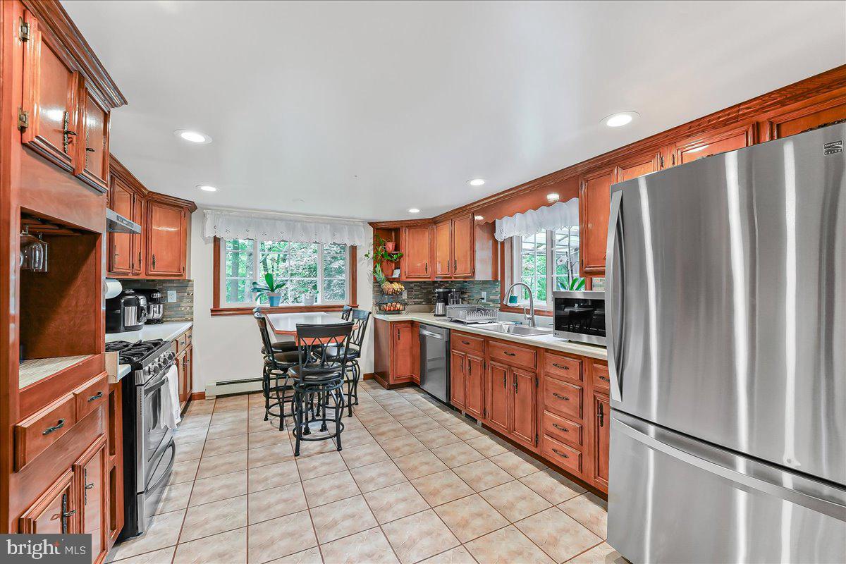320 Lees Bridge Road Nottingham, PA 19362 - Photo 13 of 45 a kitchen with stainless steel appliances granite countertop a refrigerator and a stove top oven