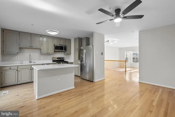 a kitchen with a refrigerator and a stove top oven