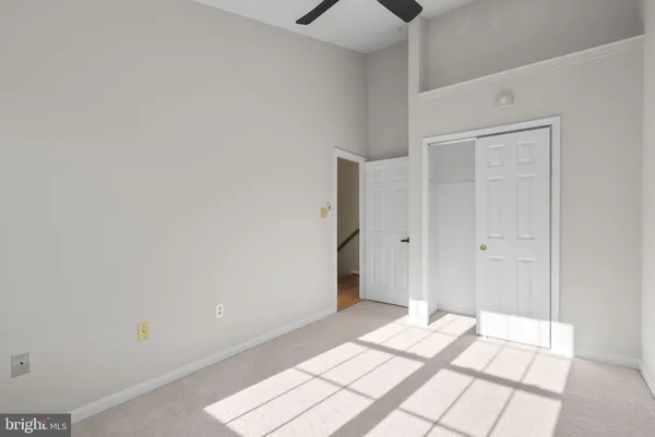 a view of a bedroom with wooden floor and bathroom
