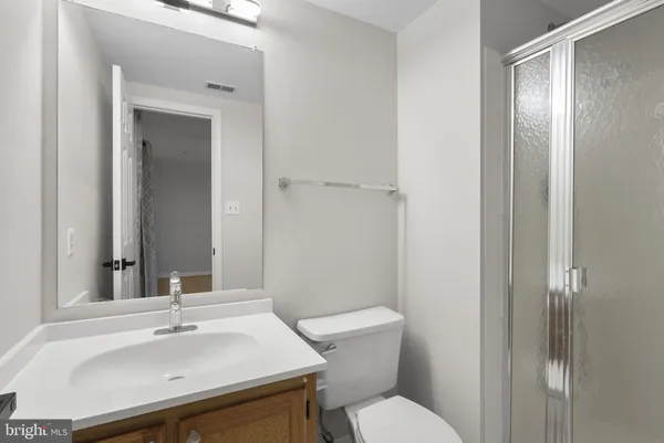 a bathroom with a sink toilet and mirror
