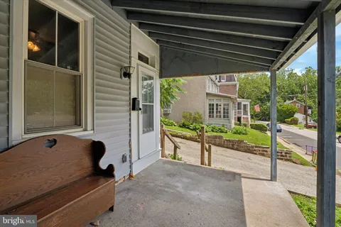 a blue bench sitting in front of a building