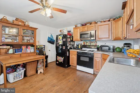 a kitchen with stainless steel appliances granite countertop a stove and a refrigerator
