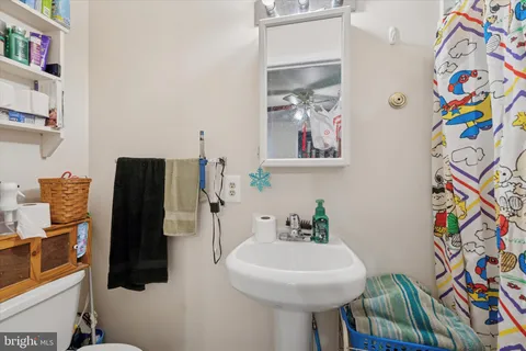 a bathroom with a sink mirror and vanity