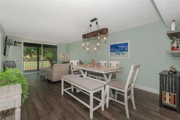 a view of a dining room with furniture wooden floor and potted plants