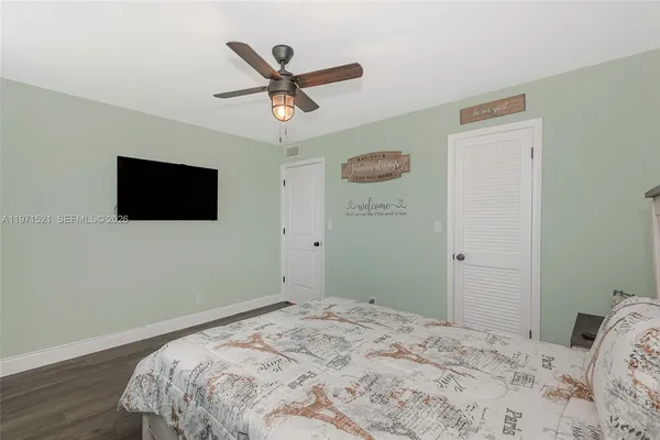 a bedroom with a bed and a painting on the wall