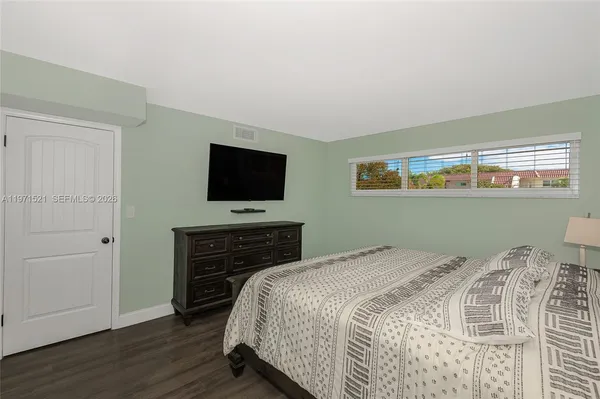 a bedroom with a bed and a night stand