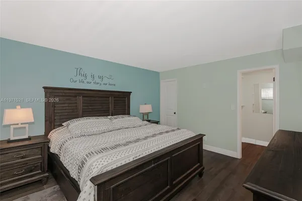 a bedroom with a flat screen tv and a bed