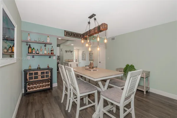 a dining room with a table and chairs