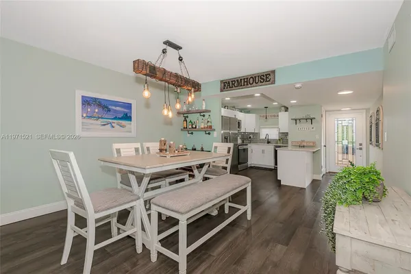 a kitchen with a refrigerator sink and cabinets
