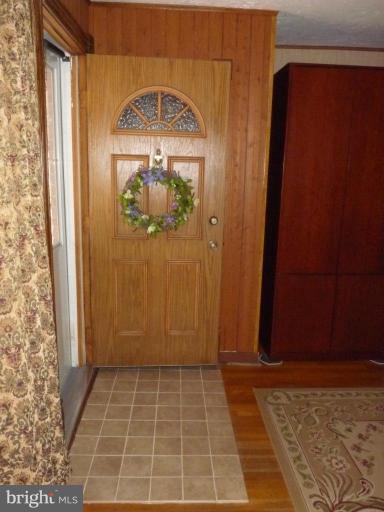 444 Stemmers Run Road Essex, MD 21221 - Photo 3 of 30 an empty room with wooden floor and a window