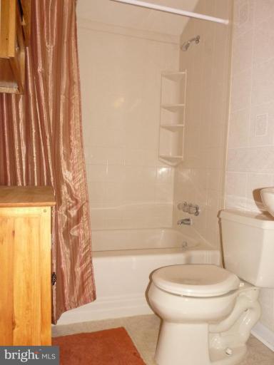 444 Stemmers Run Road Essex, MD 21221 - Photo 22 of 30 a white toilet sitting next to a bath tub
