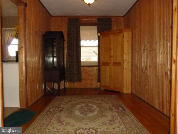 444 Stemmers Run Road Essex, MD 21221 - Photo 6 of 30 a view of a hallway with wooden floor and a bathroom