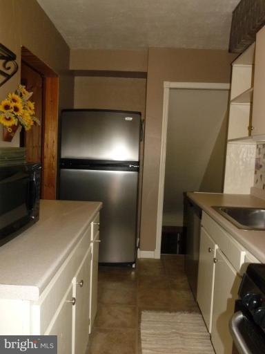 444 Stemmers Run Road Essex, MD 21221 - Photo 8 of 30 a kitchen with a refrigerator and a stove