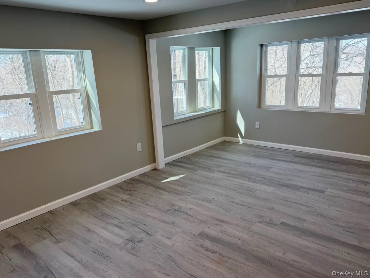 9 Underhill Trail Monroe, NY 10950 - Photo 17 of 18 an empty room with wooden floor and windows
