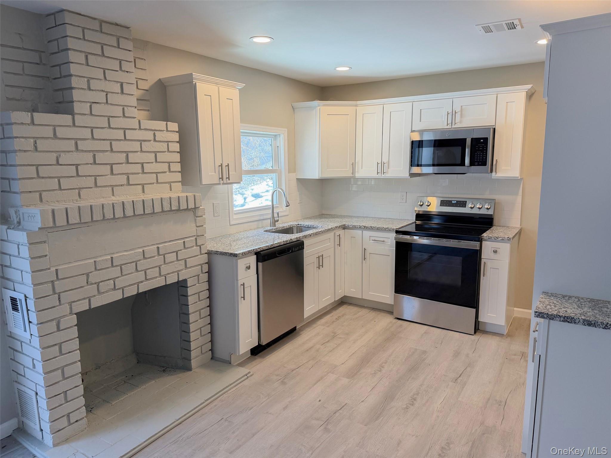 9 Underhill Trail Monroe, NY 10950 - Photo 4 of 18 a kitchen with stainless steel appliances granite countertop a stove top oven a sink and a refrigerator