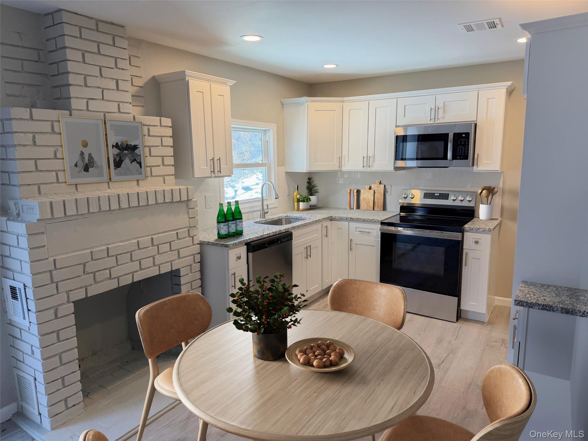 9 Underhill Trail Monroe, NY 10950 - Photo 5 of 18 a kitchen with a table chairs sink and stove