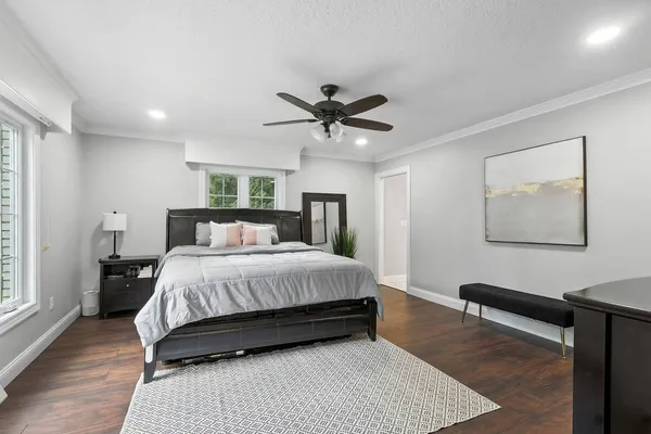 a bedroom with a bed and a ceiling fan