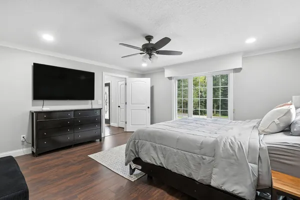 a bedroom with a bed and a flat screen tv