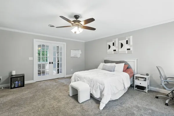 a bedroom with a bed and a chandelier