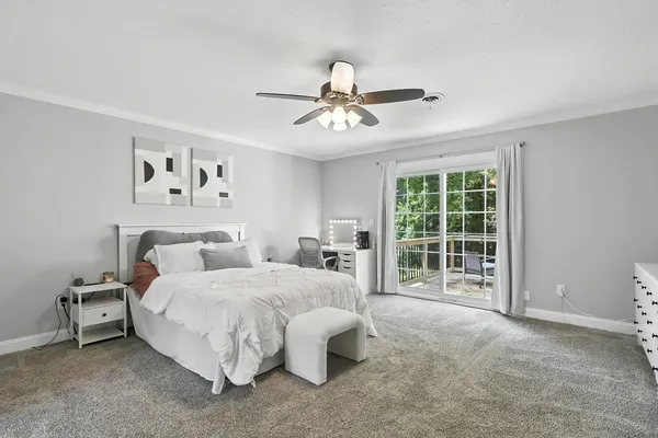 a bedroom with a bed couch and window