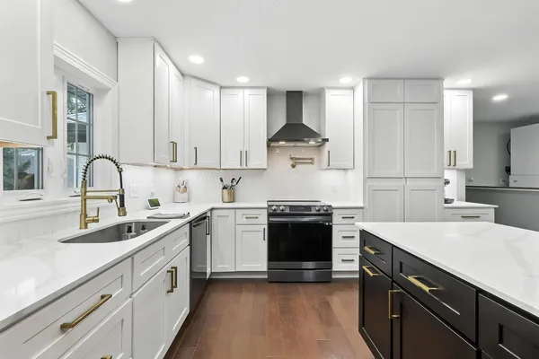 a kitchen with a sink appliances and cabinets