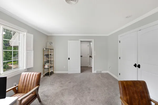 a bedroom with furniture and a window