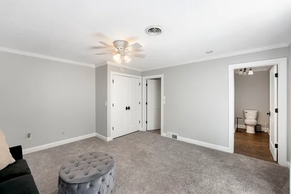 wooden floor in an empty room with a bathroom
