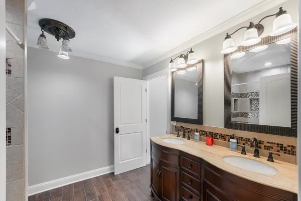 a bathroom with a double vanity sink and mirror
